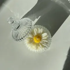 This daisy candle is hand-poured into a stunning vintage-style glass carousel jar with a lid. It's a beautiful decorative piece, even when not lit.