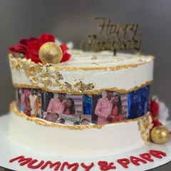 A personalized fault line anniversary cake with a photo strip of the couple.