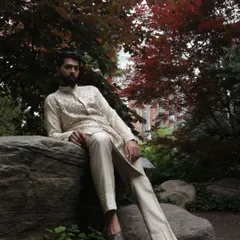 Set against a natural backdrop, the ivory mirror work kurta exudes a quiet confidence. It's a versatile piece, perfect for a daytime wedding event or an evening festival celebration.