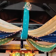 A closer look at the colorful ceiling drapes for the Mehendi ceremony. The combination of rich jewel tones and soft cream fabric, accented with lights, adds a celebratory feel to the space.