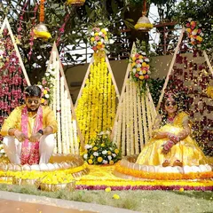 For Sukriti and Rahul's "Phoolon ki Haldi," we created this vibrant floral backdrop. Using geometric frames decorated with red and yellow flowers, we designed a cheerful and picturesque setting for the couple's ceremony.