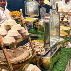 Tantalize your taste buds at our flavour carnival. This chaat counter display, with its stacks of bowls and traditional brass pots, invites guests to indulge in a variety of crunchy and tangy treats.