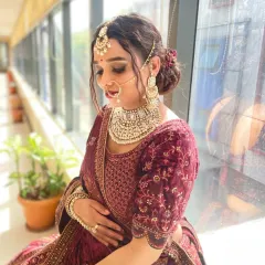 This royal bridal makeup, created by one of my talented students, captures the essence of North Indian wedding traditions. The focus is on creating a regal look with a rich color palette and statement jewelry.