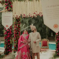 The first official portrait as husband and wife. Standing before the stunning floral mandap, this image captures the couple's grace and the solemn beauty of the moment.