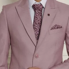 Summer occasion wear calls for pastel colours. This close-up highlights the beautiful fabric and paisley tie of our pastel pink three-piece suit, a refreshing choice for daytime events.