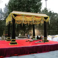 A straight-on view of the traditional outdoor mandap, showing the structure and floral decoration in full. This design is perfect for clients who want a classic wedding ceremony with a natural, open-air feel.
