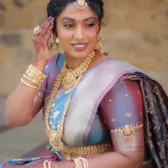 A happy and confident look. This image shows the bajuband (armlet) and bangles that are also part of this extensive temple jewellery rental set.