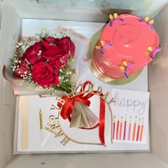 Surprises taste sweeter in a hamper. This custom birthday box includes a pretty pink cake, a bouquet of red roses, a birthday crown, and a card.