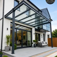 Our pergolas are designed to be a natural extension of modern architecture. This sleek glass canopy seamlessly integrates with the home's facade, enhancing its contemporary design while providing a functional and stylish covering for the patio.