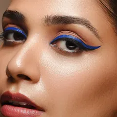 An even tighter crop from our blue eyeliner series, this image shows the detail and precision of the makeup application. This type of macro beauty shot is ideal for showcasing specific cosmetic products or techniques.