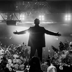A groom's solo performance is always a heartfelt surprise. This dramatic, silhouetted shot captures the emotion and power of his performance, a moment dedicated entirely to his bride.