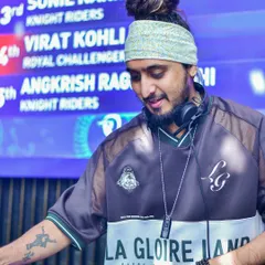 A close-up shot during a gig, with my headphones on and a smile, fully absorbed in the music and the moment.
