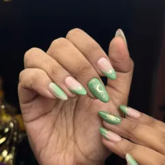 This trendy design features a sage green base with delicate, gold celestial symbols. The mix of solid and negative-space nails keeps it modern and fresh.