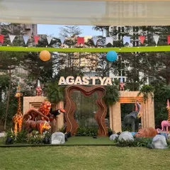 For this 'Wild Two' jungle themed birthday, we created a massive custom stage with marquee letters, a waterfall feature, and life-sized animal props to serve as the perfect backdrop for the celebration.