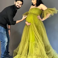 From baby kicks to fashion flicks, this journey is all heart. This playful shot shows the fun and excitement of expecting, with the dad-to-be admiring the bump. The olive green tulle gown and his simple black shirt make a great pair for a studio shoot.