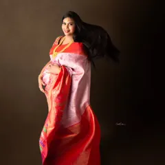 A joyful, dynamic shot with the mom-to-be's hair and saree fabric caught in motion, creating a feeling of celebration.