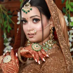 A stunning bride in a bronze-gold lehenga. The makeup is warm and glowing, with a focus on her beautiful eyes.