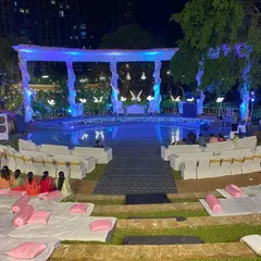 This wide shot shows the tiered seating arrangement for a reception event, offering clear views of the main stage. We provide flexible layouts, including a mix of formal chairs and casual floor seating with cushions, to suit the event's tone.