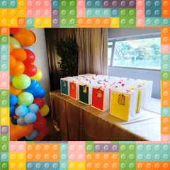 A large order of building block themed hampers, all set up at the party venue. The colorful bags add to the festive decor.