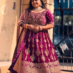 This rich magenta velvet lehenga is for the bride who wants a traditional yet unique colour. The gold embroidery shines beautifully, making it perfect for your wedding day.