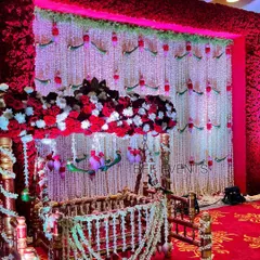 A full view of the cradle ceremony setup. The cradle is the centerpiece, surrounded by a stunning backdrop of fresh flowers and traditional elements, creating a perfect setting for the ceremony.