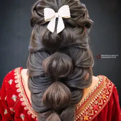 A front view of the incredible bubble braid, showcasing its volume and intricate structure. The white bow adds a sweet, feminine touch to this otherwise bold hairstyle.