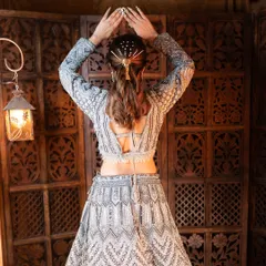 The complete look of this silver-grey lehenga is perfect for making a statement. The combination of traditional embroidery with a modern silhouette makes it a versatile choice for any wedding party.