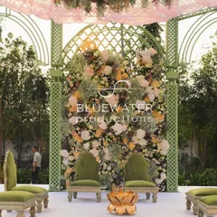 The heart of the mandap, where a dense wall of pastel flowers creates a stunning backdrop for the ceremony seating.