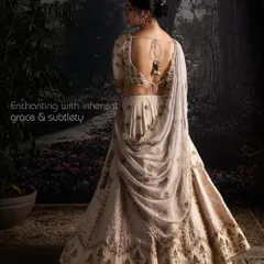 This Moonga Silk lehenga, with its enchanting back detail and gentle brocade touches, offers a vision of understated opulence. The artful drape and exquisite craftsmanship are designed for a bride with a subtle yet commanding presence.