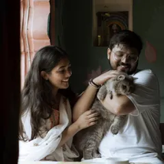 A heartwarming and authentic moment as the couple shares a laugh while cuddling their beloved cat. Including pets makes a pre-wedding shoot truly personal.