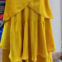 A detailed shot of the layered skirt for a custom Indo-Western lehenga. Each tier is carefully stitched to create a full, flowing silhouette that is both modern and festive.