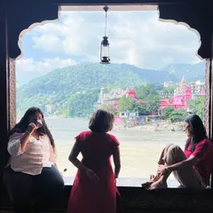 Participants enjoy a quiet moment of conversation and reflection, looking out at the river and mountains. Our retreats balance structured practice with ample free time for personal rest and connection.