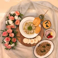 This is my modern take on a seafood classic, the Green Chili Malai Prawns platter. It features succulent Andaman prawns in a creamy butter sauce, served as a complete meal with pulao, chutneys, and dips for a full dining experience.
