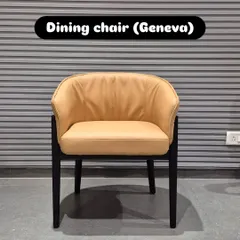 A front view of the 'Geneva' dining chair, highlighting its plush seat and enveloping backrest.