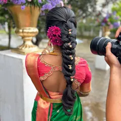 Another angle showcasing the detailed hairstyling and how the saree drape complements the overall bridal ensemble. The rich texture of the silk saree is evident here.