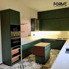 Another view of the matte green U-shaped kitchen, showing the tall unit with an integrated oven and microwave. This layout provides a highly efficient workspace with everything organized and accessible.