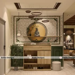 The foyer of this home makes a peaceful first impression. It features a serene Buddha statue set within a circular niche, complemented by traditional wallpaper motifs and modern ring pendant lights, blending spirituality with contemporary design.