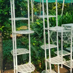 For corners and small spaces, I have these tall, multi-level design stands. You can place many pots vertically, saving floor space. Booking is open, just contact me at Saurav Nursery.