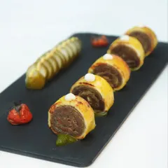 Not just paneer, but paneer dressed for the occasion. Here, it is baked and rolled with a savoury filling, then sliced and served with a vibrant coriander pesto and charred tomato.
