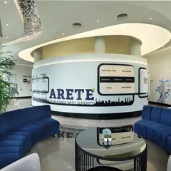 The reception and lounge area of a high-end corporate center, featuring a central, circular information hub with integrated graphics. The curved blue sofas and plush armchairs create a comfortable and sophisticated waiting area for visitors.