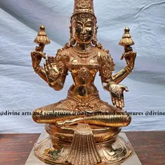 A finished masterpiece of Mahalakshmi, the goddess of wealth and fortune, cast in gleaming bronze. Notice the fine details in her adornments and the serene expression, all achieved through hours of careful chiseling and polishing by our artisans.