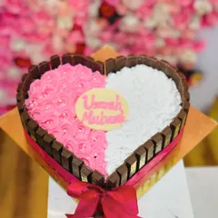 A perfect gift for your loved one. This heart-shaped cake is framed with KitKat bars and features a dual-tone frosting of pink and white. I can add any custom message on the white chocolate plaque to make it a truly personal and delicious gift.