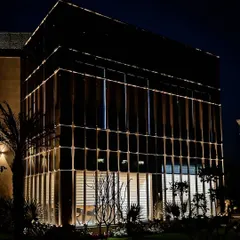 A full view of the illuminated office block in Zirakpur. The lighting is integrated directly into the facade's grid structure, creating a clean, modern aesthetic that reinforces the building's corporate function.