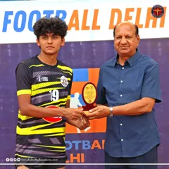 One of my players receives the "Best Player of the Match" award from a Football Delhi official after an outstanding performance in a B Division league game.