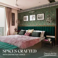 This bedroom is a sanctuary crafted with distinctive grace. The rich green velvet headboard, custom floral wallpaper, and unique pendant lights create a space that feels like a personal staycation, blending opulence with tranquility.