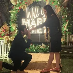 A picture-perfect proposal in front of a custom "Will You Marry Me" neon sign, framed by a beautiful floral arch. I ensure every detail is ready for that unforgettable question.