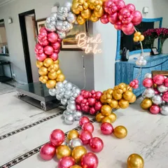 This vibrant balloon ring for a bridal shower uses a mix of hot pink, gold, and silver metallic balloons. The "Bride to be" neon sign at the center ensures the bride-to-be is the star of every photo.