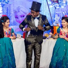 A great shot from a Frozen themed birthday party where two young audience members became my magical assistants for a trick. Their smiles say it all.