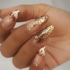 A high-quality, professional shot showcasing the intricate 3D gold filigree and crystal nail art.
