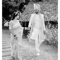 A graceful walk through a heritage resort. The monochrome conversion gives this image a classic, elegant feel, focusing on their poised connection and the beautiful textures of the location.